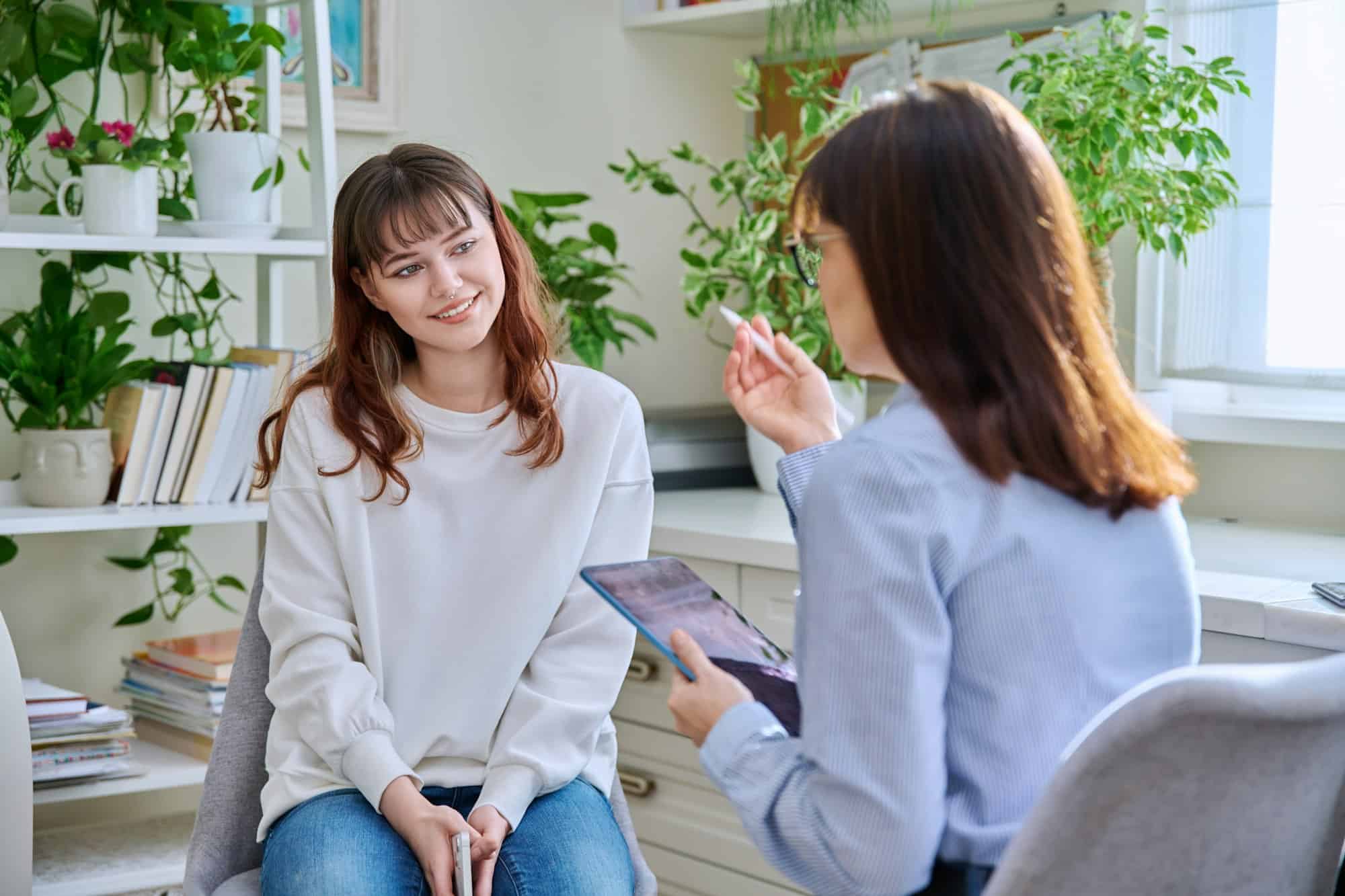 Teenage girl at therapy session with mental health professional