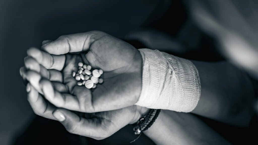 Medication Overdose: Female Hands Holding Pills