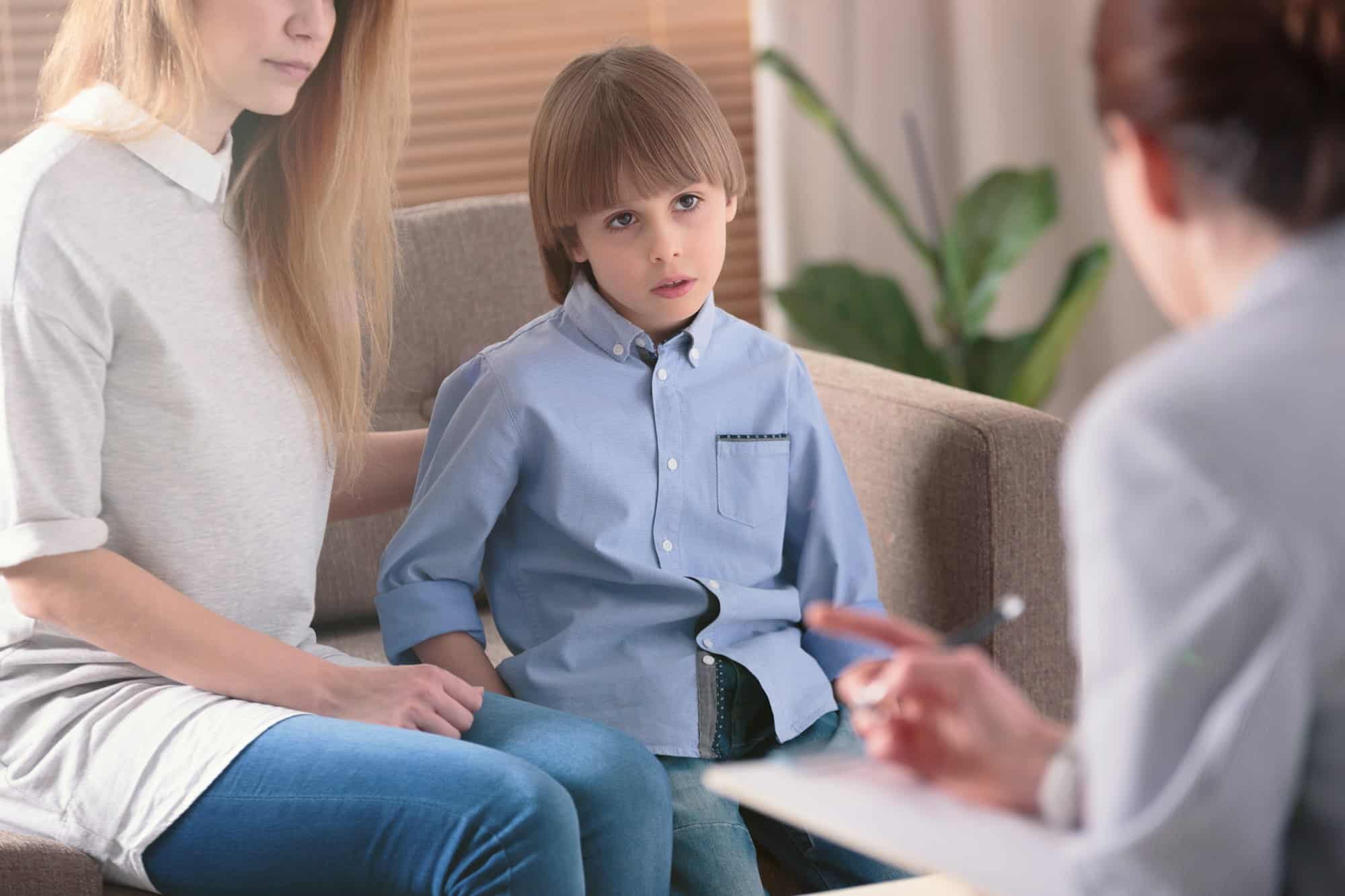 Autistic child listening to therapist